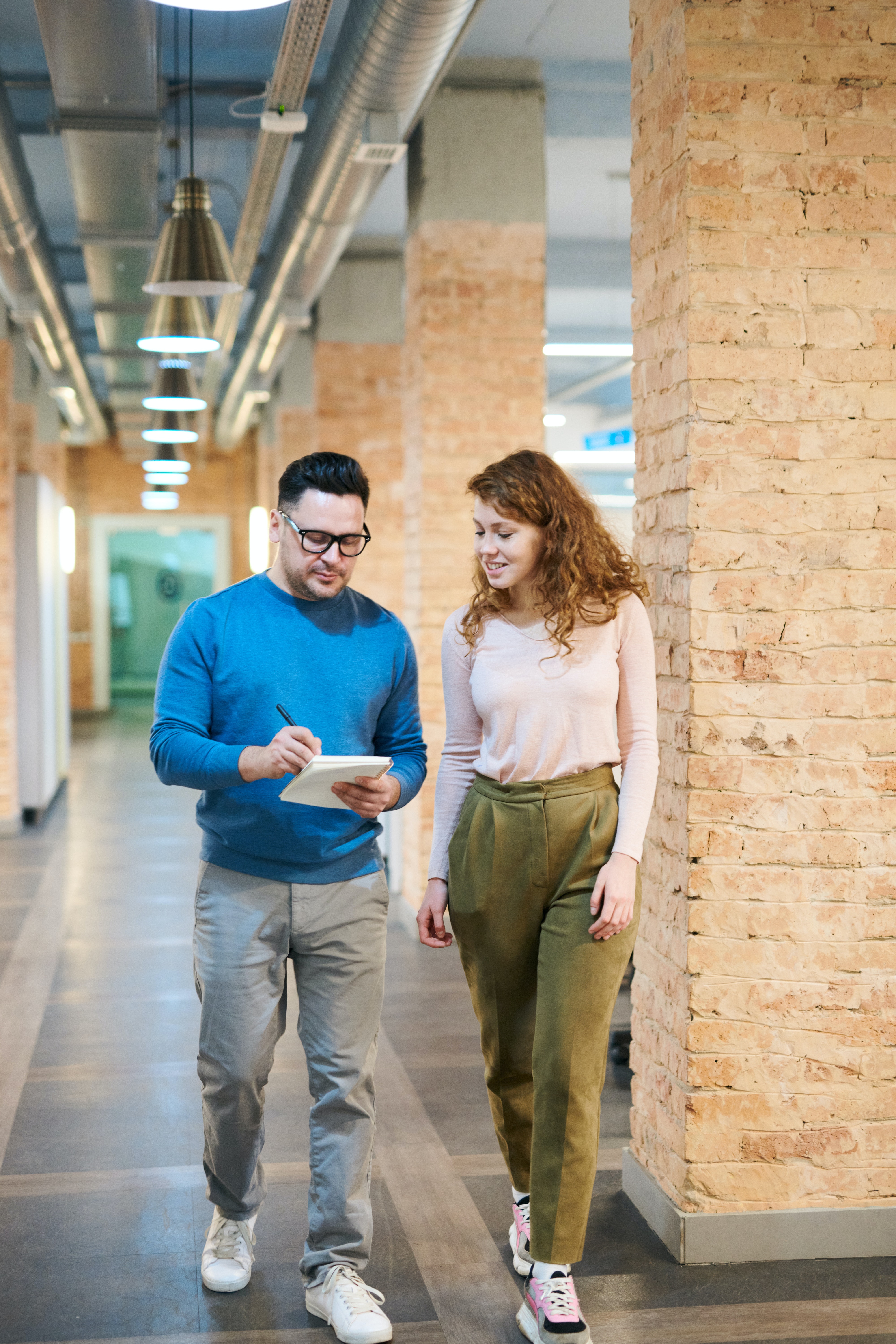 Two people talking while walking